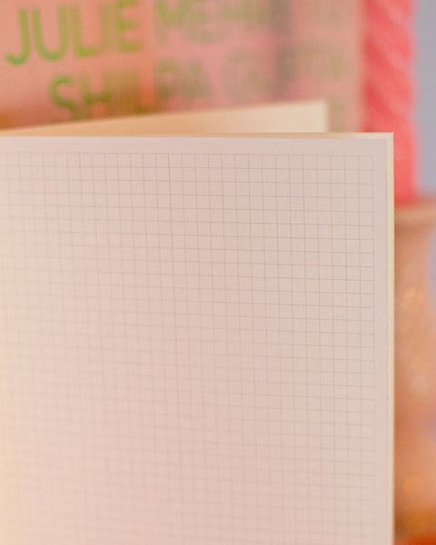 Close-up detail of the inside of a notebook with graph paper.
