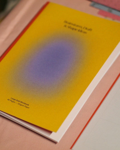 Close-up details shot of a yellow and orange notebook
