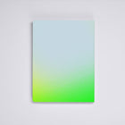 Nuuna neon green bullet journal lying face down on a light grey background