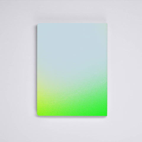 Nuuna neon green bullet journal lying face down on a light grey background