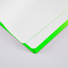 Close-up of neon green recycled leather bullet journal showing the dotted and numbered inner pages and vibrant green colored edges