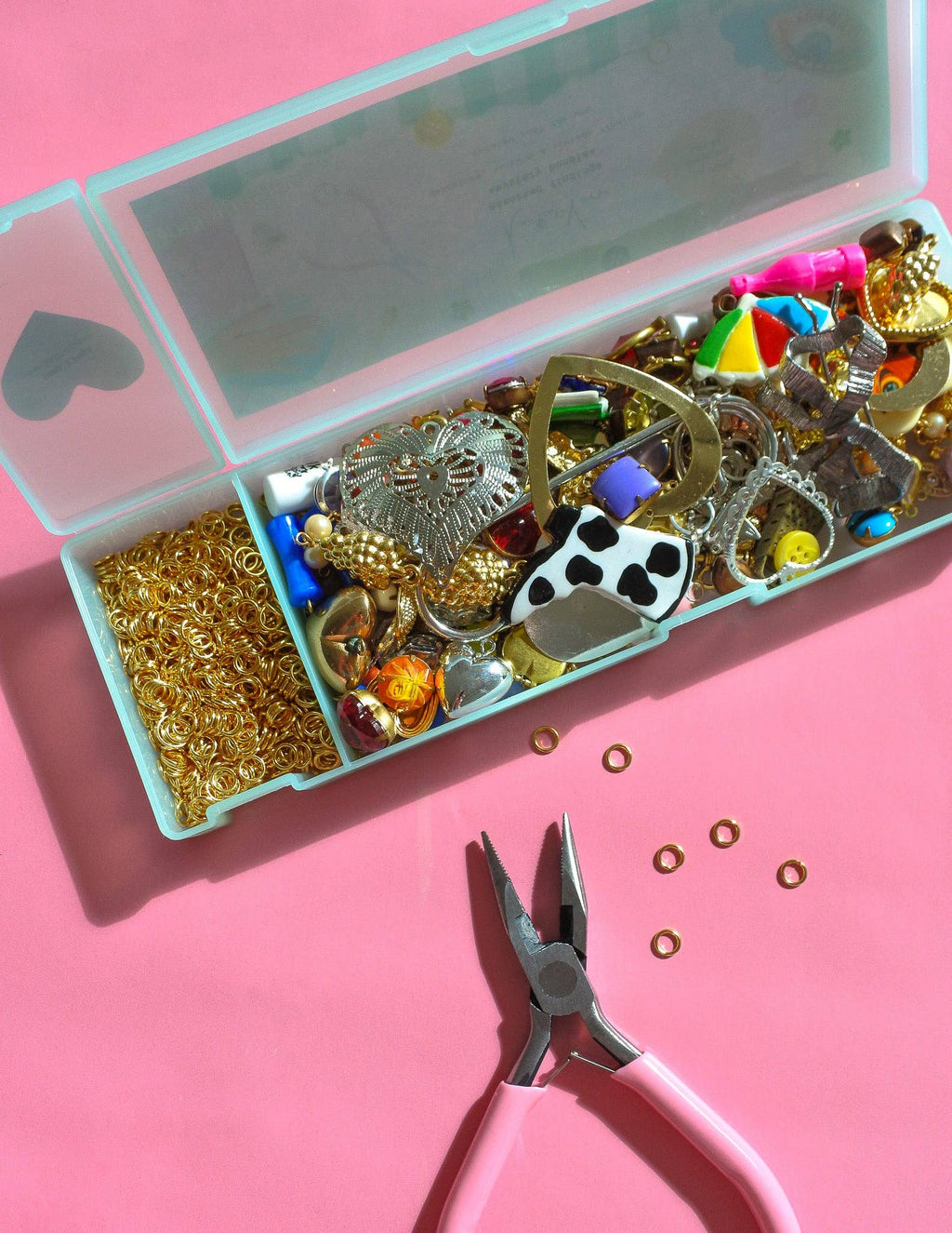 Assorted vintage charms and jewelry findings from Haricot Vert Mystery Bundle for journal decoration and craft projects
