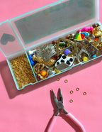 Assorted vintage charms and jewelry findings from Haricot Vert Mystery Bundle for journal decoration and craft projects