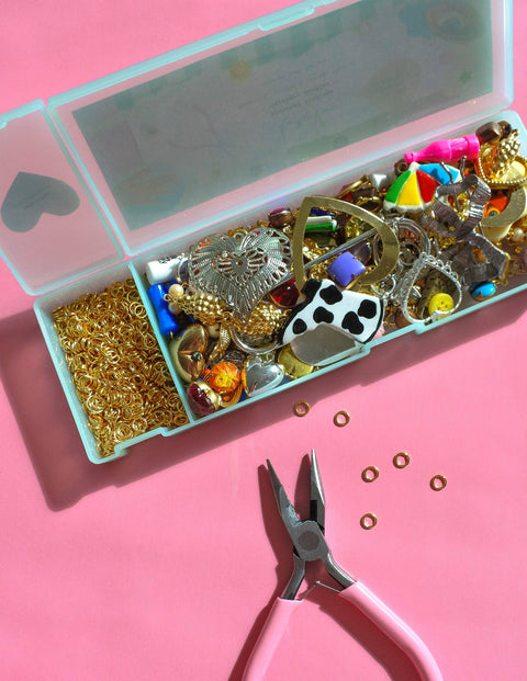 Assorted vintage charms and jewelry findings from Haricot Vert Mystery Bundle for journal decoration and craft projects