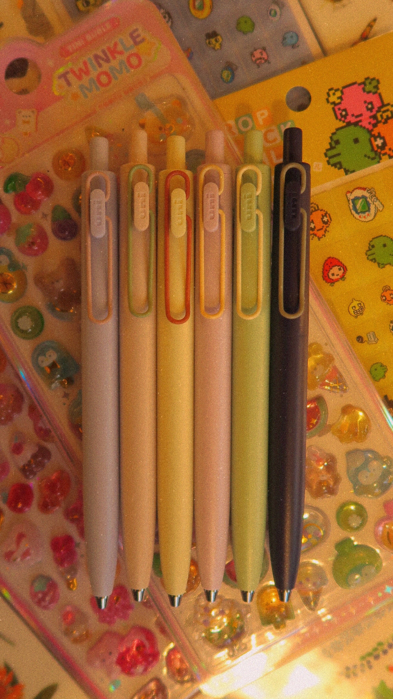 Set of colorful pens on a decorative background with stickers